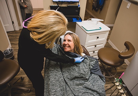 Relaxed patient in dental chair under blanket