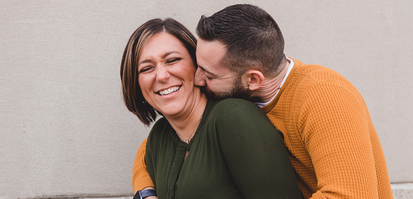 Laughing man and woman visiting our modern dental office