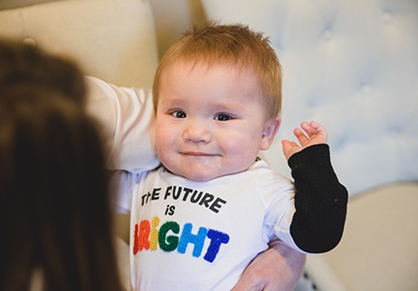 Smiling infant at dental exam for thumb sucking habit