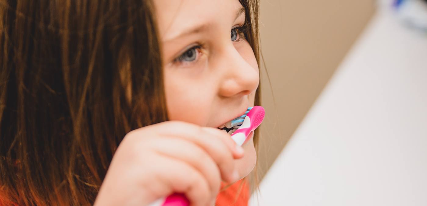 Child practicing tooth brushing