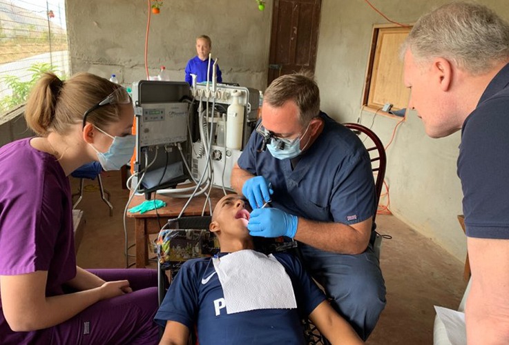 Doctor Owens performing dental exam on mission trip