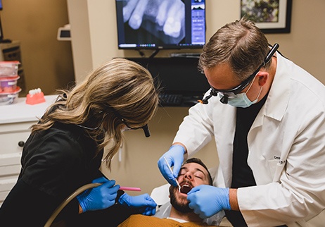 Dentist placing dental bonding treatment