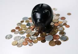 Black piggy bank and loose coins