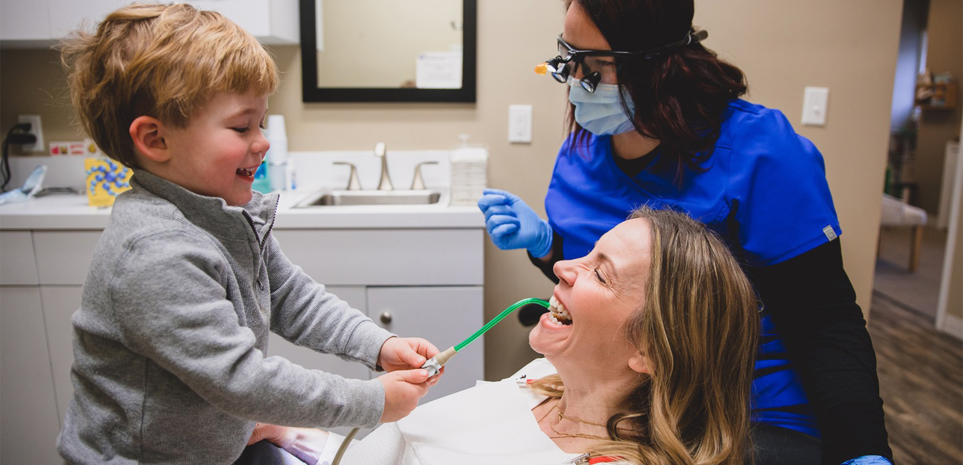 Dental team member mother and son in dental exam room