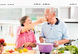 older couple enjoying eating a healthy diet with their implants in Geneva