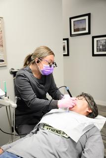 Dentist and team member placing tooth-colored filling