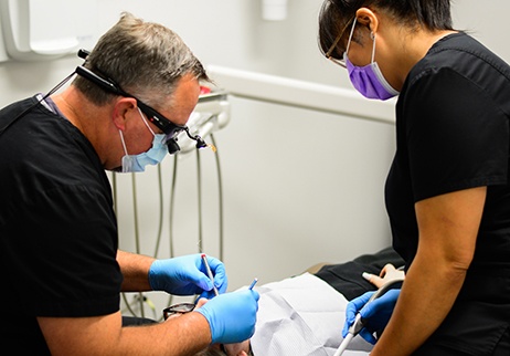 Dentist talking to patient about dental crowns and bridges