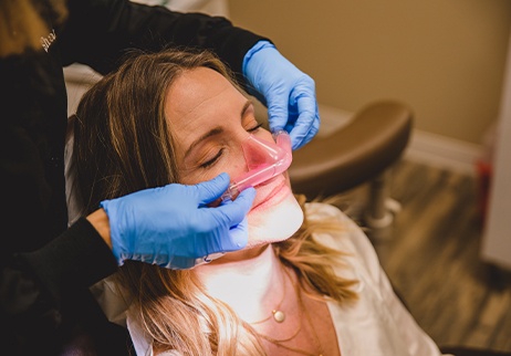 Dental team member placing nitrous oxide nose mask