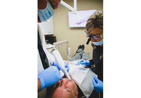 Dentist capturing digital impressions of bite