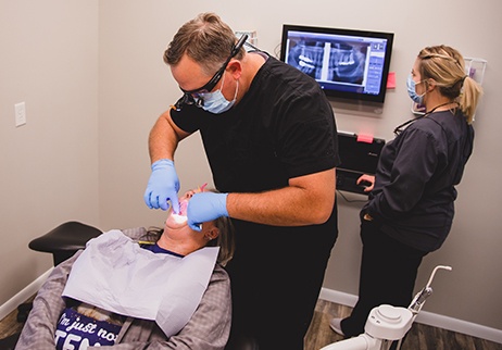 Dental team member examining bit during T M J diagnosis