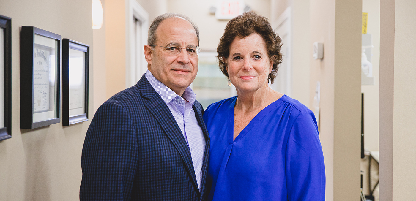 Two patients at dental office smiling