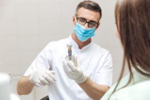 Dentist explaining dental implant surgery