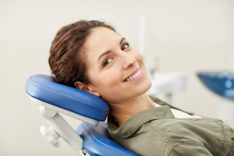 person smiling after being treated by cosmetic dentist