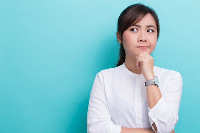 woman thinking about a chipped tooth in Geneva